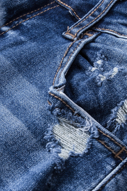 Jeans svasati a vita alta con orlo grezzo strappato blu scuro