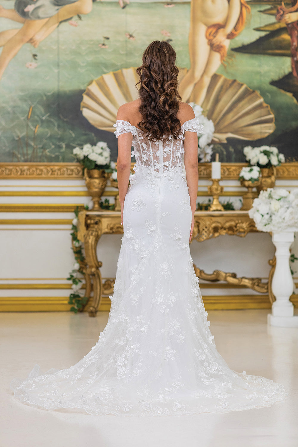 Elegant Wedding Dress with Off-Shoulder Sleeves, Sheer Bodice Featuring Floral Embellishments, and a Figure-Flattering Silhouette with a High Slit and a Flowing Train for a Romantic Bridal Look