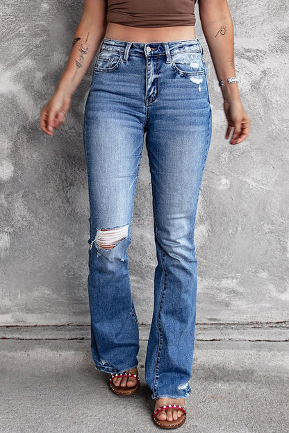 Jeans svasati a vita alta con orlo grezzo strappato blu scuro